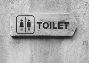 Ancient toilet sign on cement wall